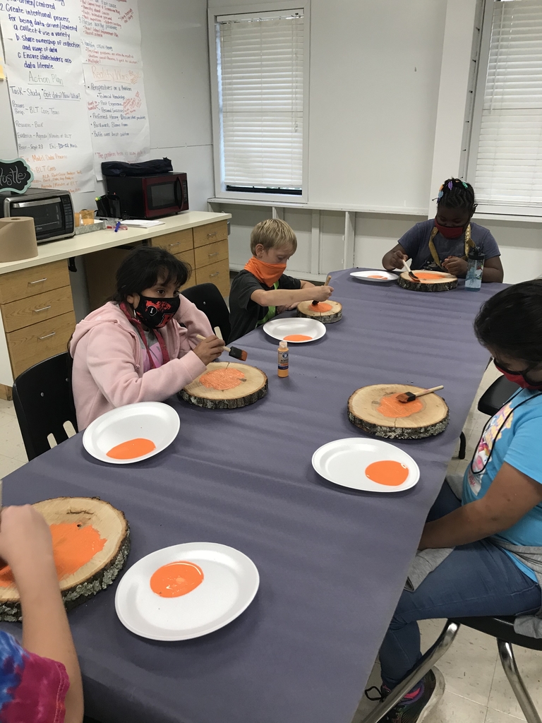 Students painting pumpkins 